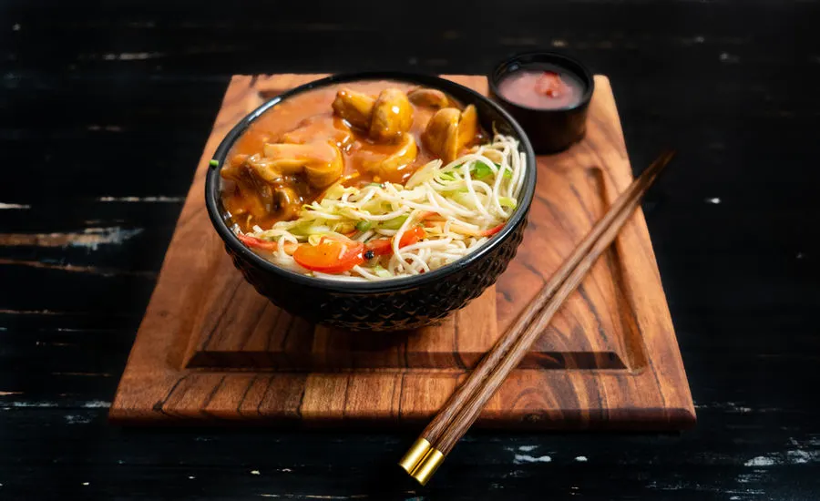 Noodle bowl on a wooden board