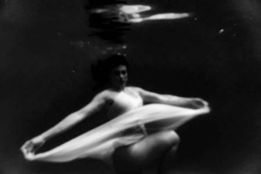Figure underwater, black and white