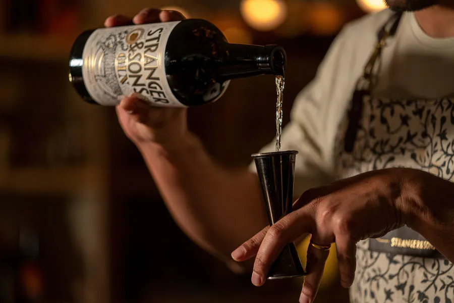 Bartender pouring a measure of gin