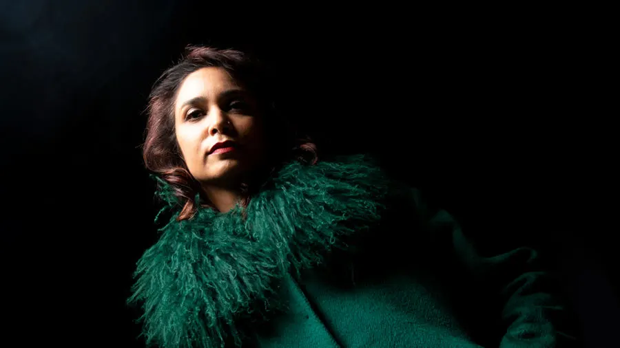 Portrait in a green feathered coat