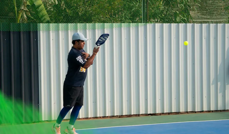 Pickleball player reaching for a shot